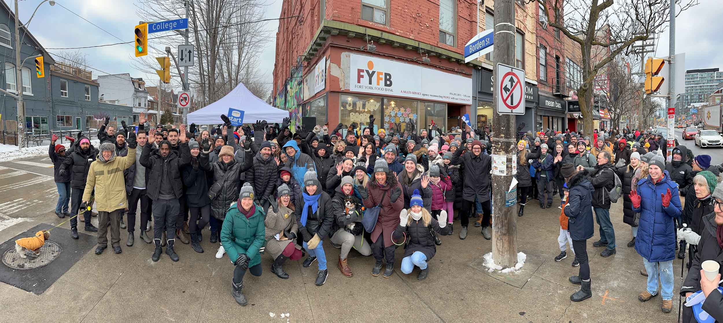 A large group of people in front of Fort York Food bank in winter