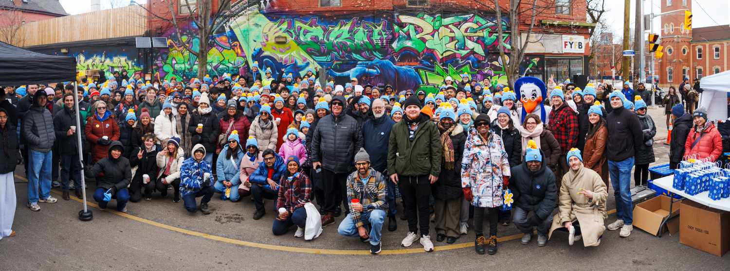 A large group pof people dressed for winter in front of Fort York Food Bank