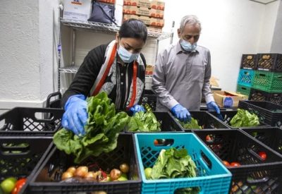 Volunteers packing food in a food bank