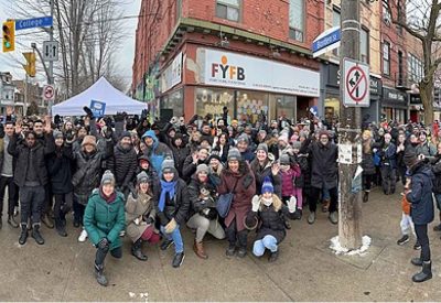 Large group of people outside Fort York Food Bank in winter